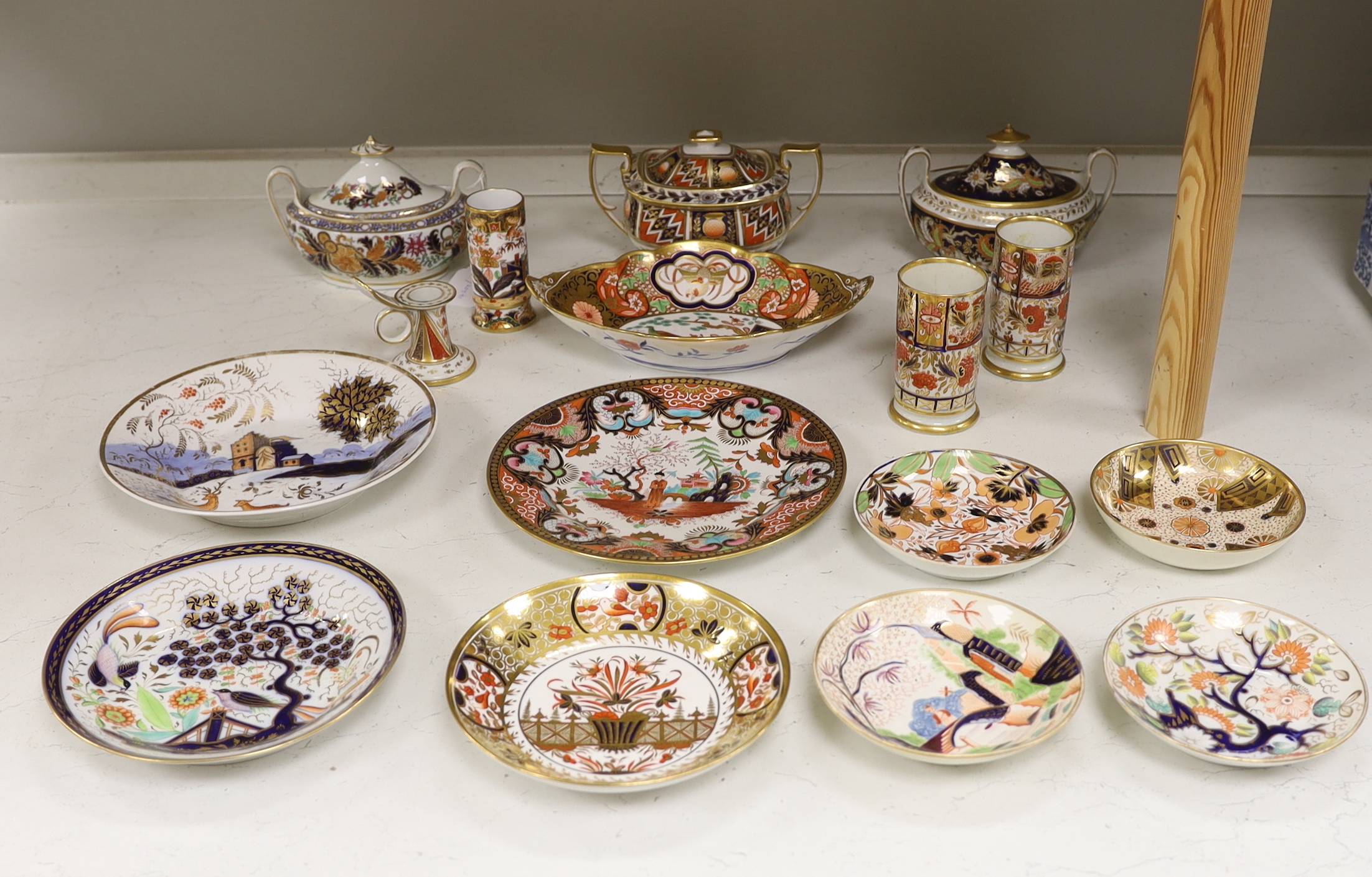 Sixteen mixed items of 1800-1820 English porcelain tableware, to include: three sucriers and covers, an oval ornately decorated dish, four saucer dishes, a candle holder, three spill vases and four saucers